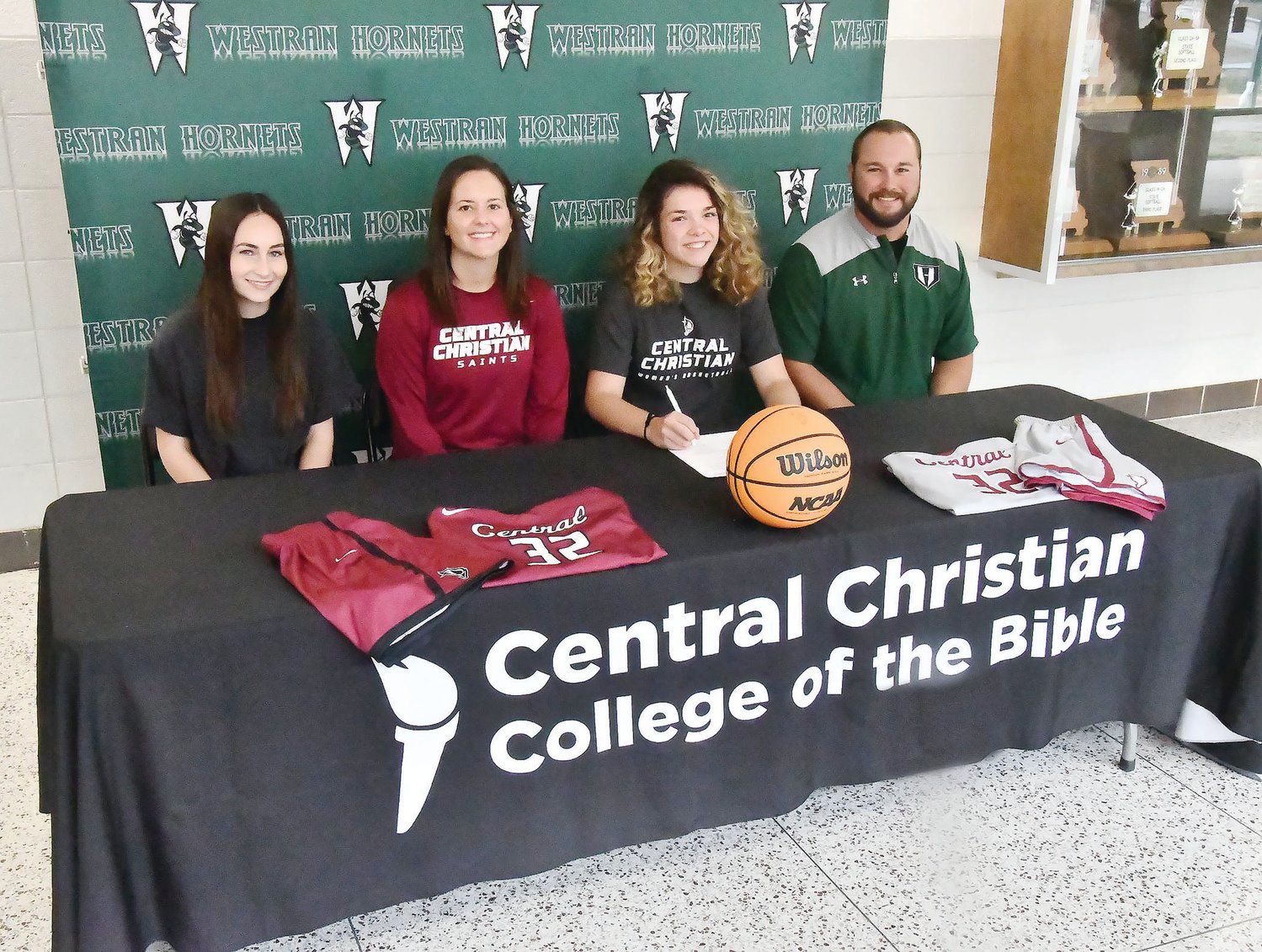 Westran's Maci Crutchfield (third from left) is shown here with Hornets' assistant girls basketball coach Caitlyn Poore, Central Christian College of The Bible head coach/athletic director Kori Zarzutzki and head coach Alex Thomas during Crutchfield's signing ceremony on Monday, Oct. 24.