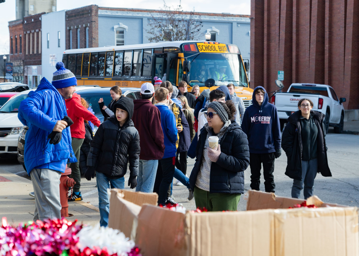 A busload of high school students arrives in downtown Moberly to help the Moberly Area Chamber of Commerce decorate for Christmas. The effort was part of the second annual Serve Like Sam Day to honor former teacher, Sam Richardson.