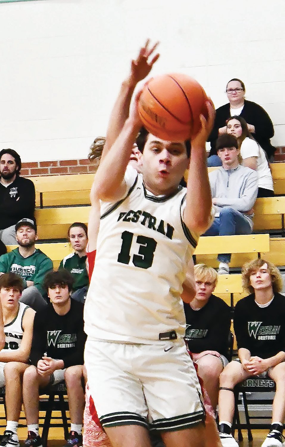 Westran's Jace Chapman makes a facial expression while coming down with a rebound during the second half.