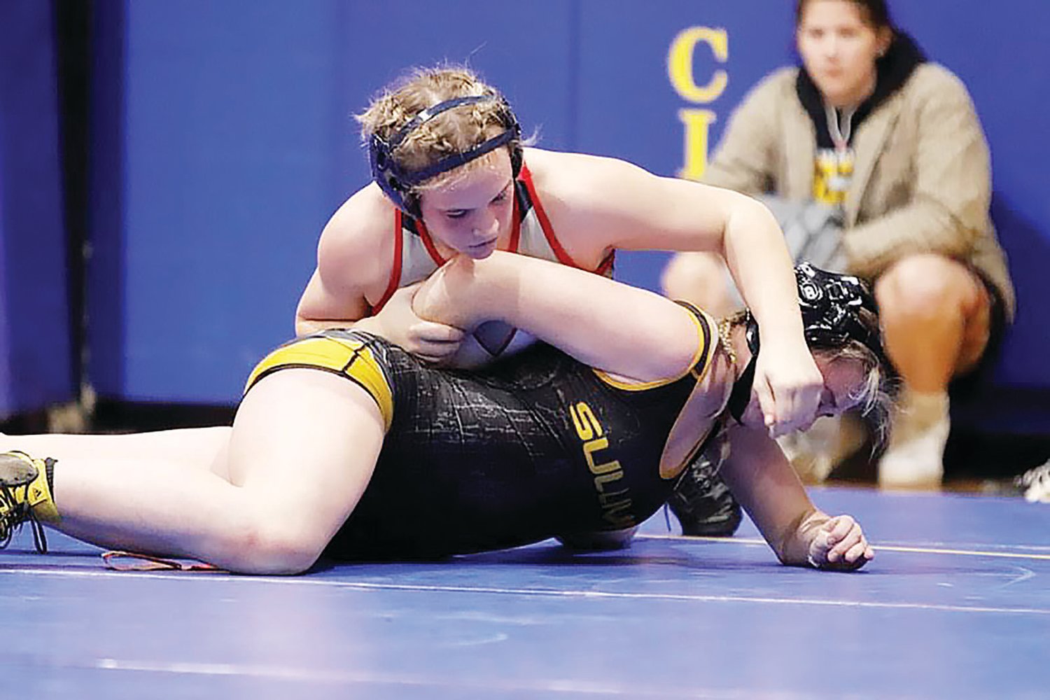 Moberly High School freshman Breanne Gibbs controls the arm while also attempting a cross face on Sullivan's Hannah Sumner during a 155-pound bout at the Wright City Invitational on Saturday.
