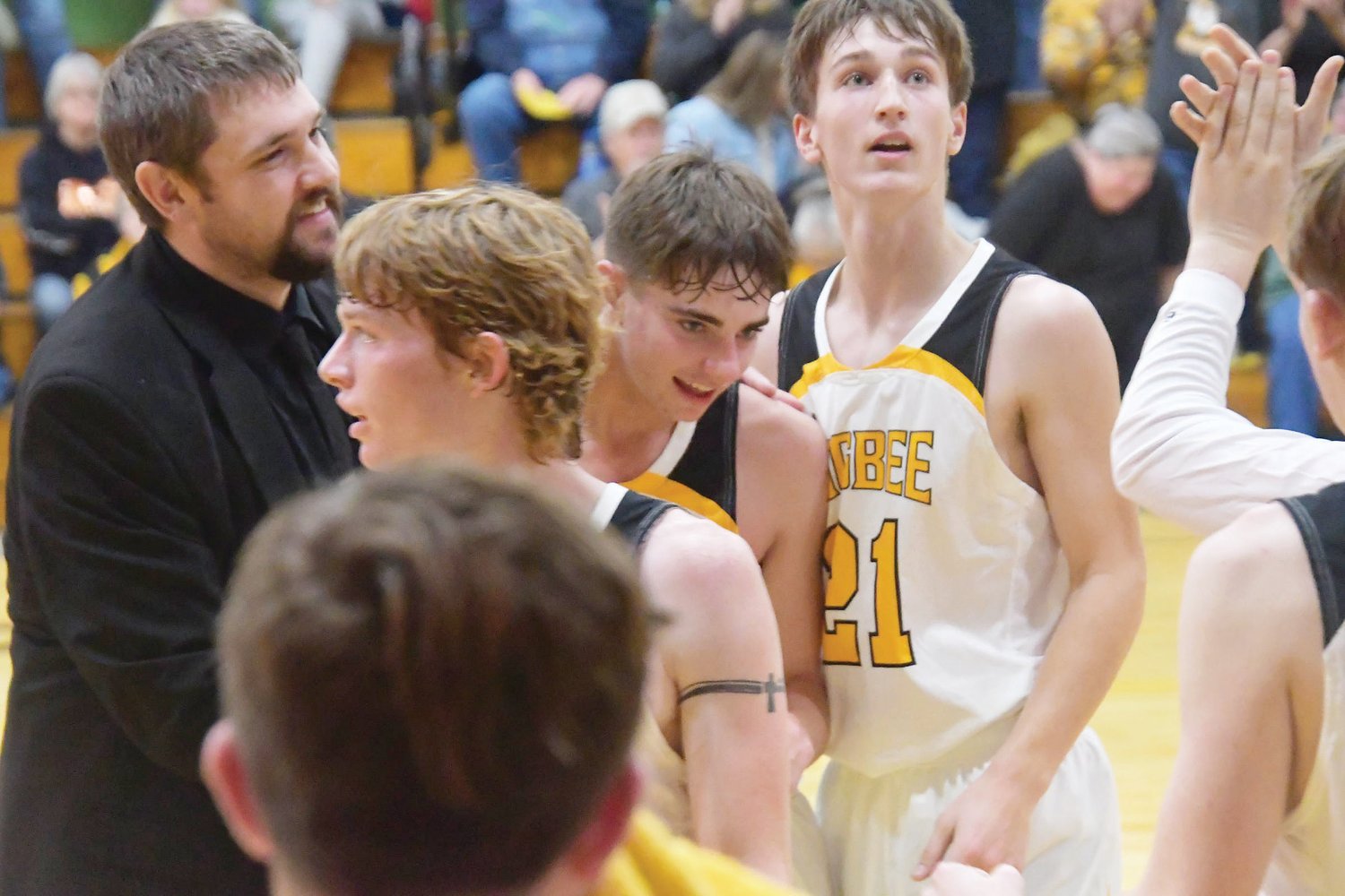 Players react after Derek Rockett scored his 1,000th point during the third quarter of Tuesday's game versus Bevier.