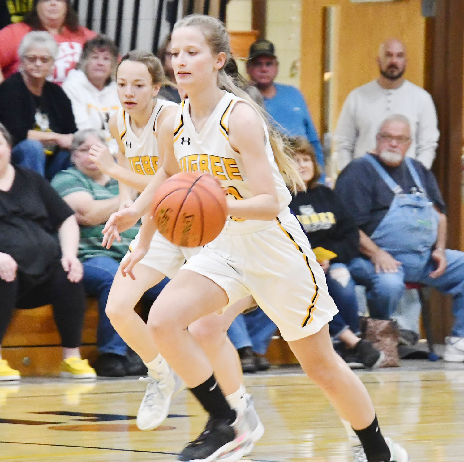 Higbee's Alie Mitchell turns up court on the fastbreak during Tuesday's game, with Raegan Derboven in the background.
