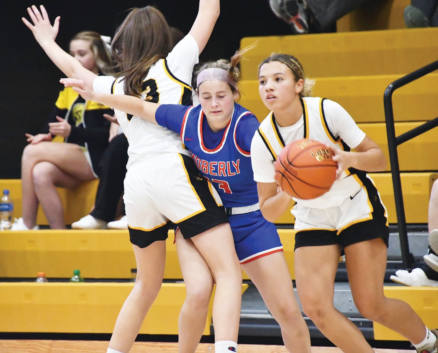 Moberly High School girls' basketball player Elizabeth Reisenauer (13) fights through a screen while playing defense during the Spartans' girls' basketball game on Monday in Monroe City. The Spartans held the Panthers to four points each in both the second and third quarter.