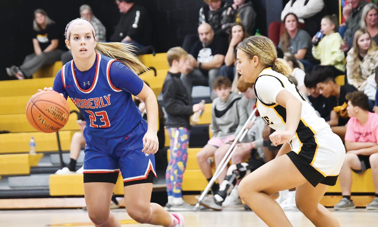 Kennedy Messer (23) dribbles into the front court during the second half of Monday's game between Moberly and Monroe City.