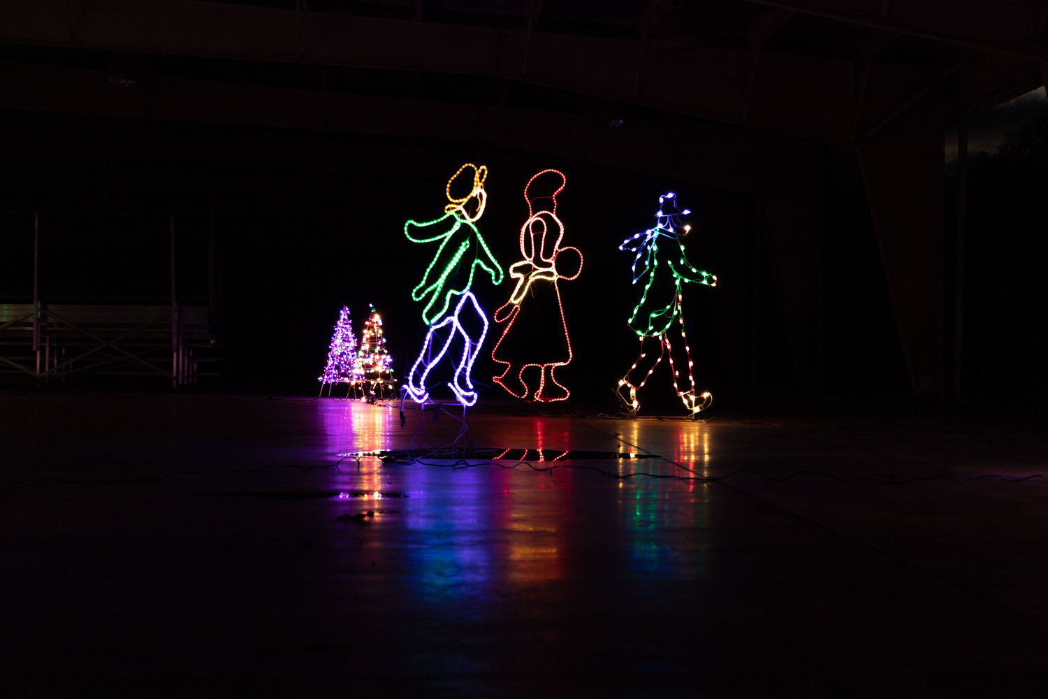 Colored lights frame ice skaters in the pavilion at Rothwell Park. Altrusa International’s annual Christmas in the Park opened this weekend and continues from 5-9 p.m. nightly through Dec. 23.