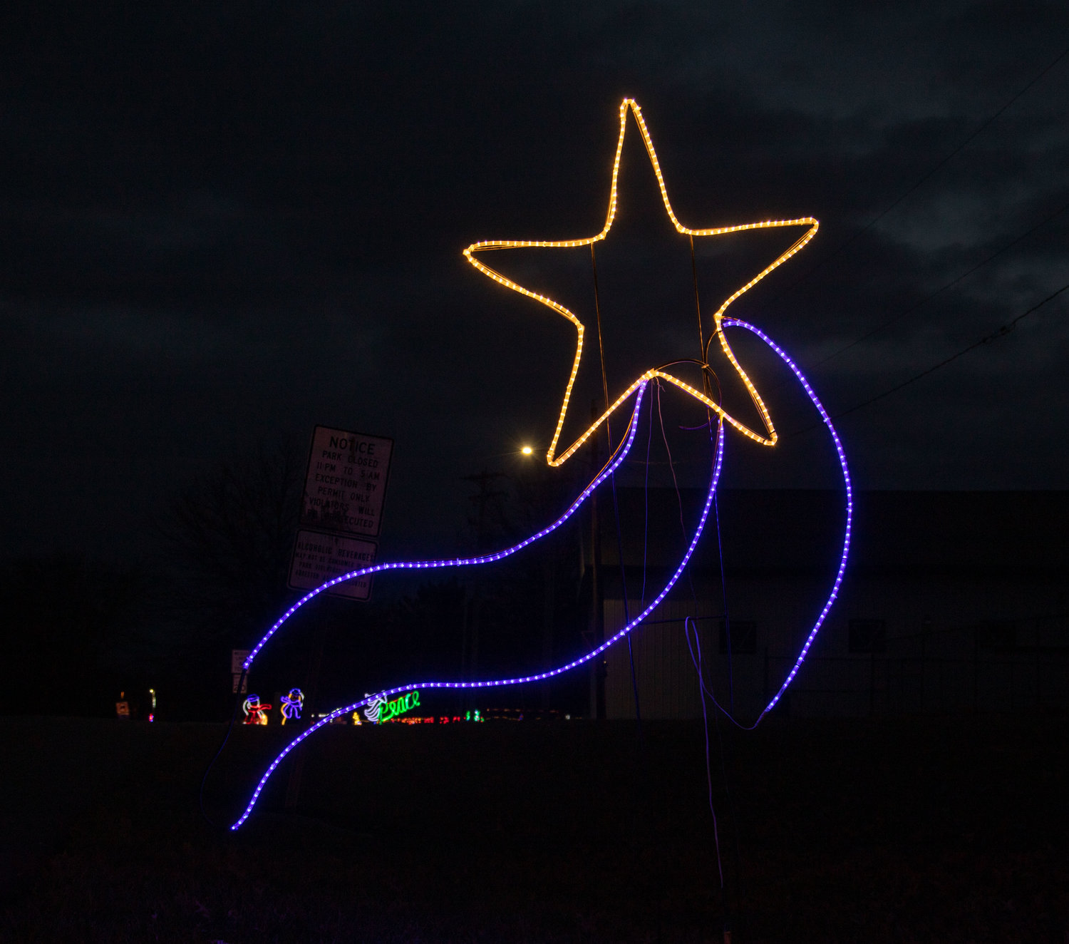 A star guides visitors to the Rothwell Park lodge to begin their drive through Altrusa International’s light display.