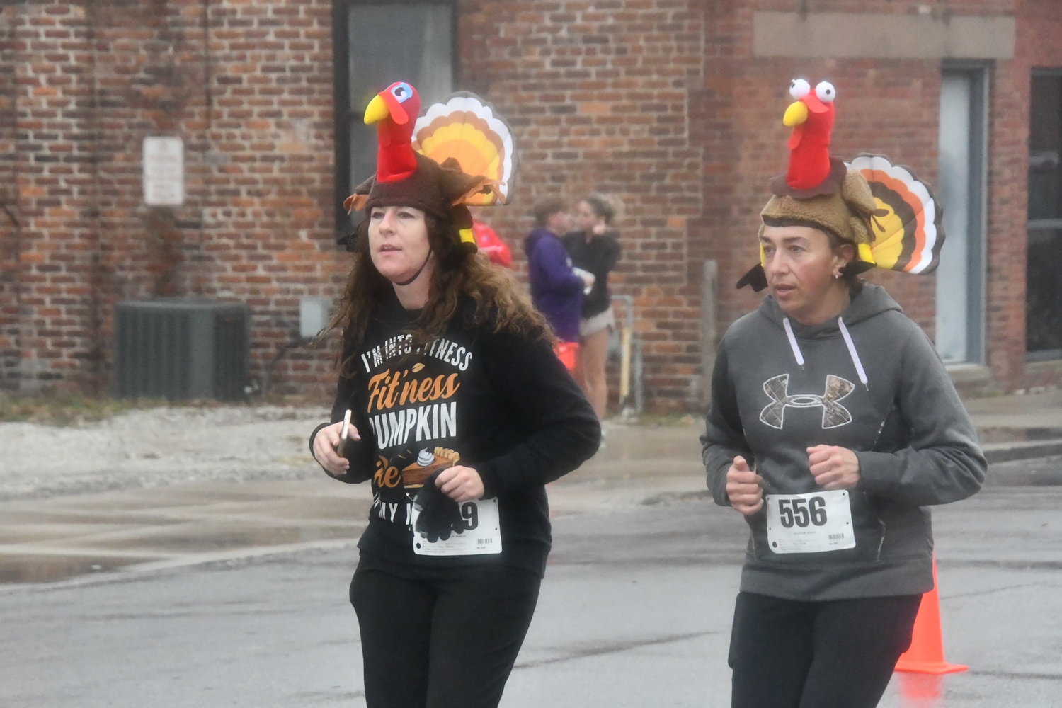 Melissa Miller (left) and Jessica Tremain wear turkey headdresses while competing during the trot on Thursday, Nov. 24.