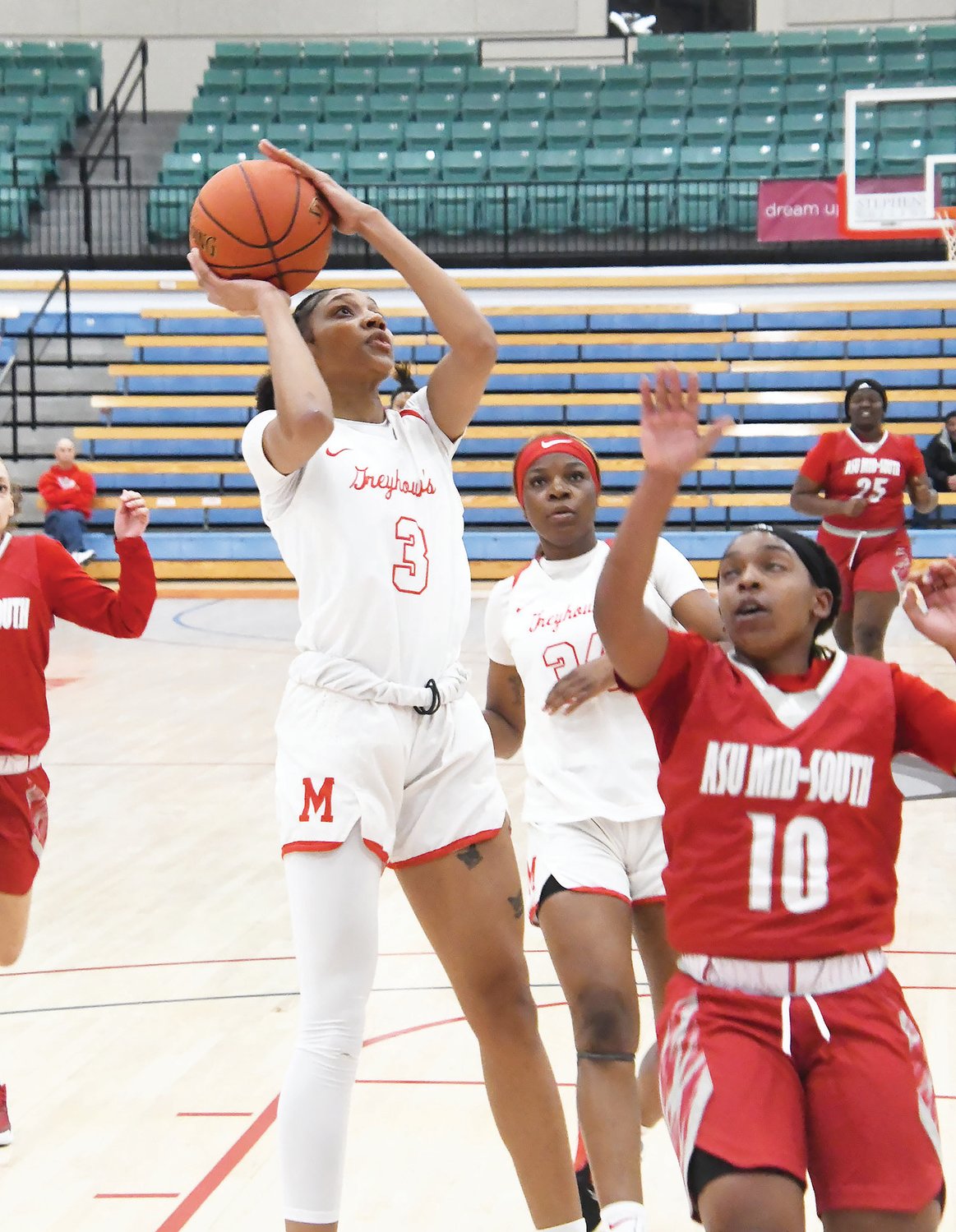 Moberly Area Community College's T'Aaliyah Miner (3) scores inside while defended by Quintasia Leatherwood from Arkansas State University Mid-South.