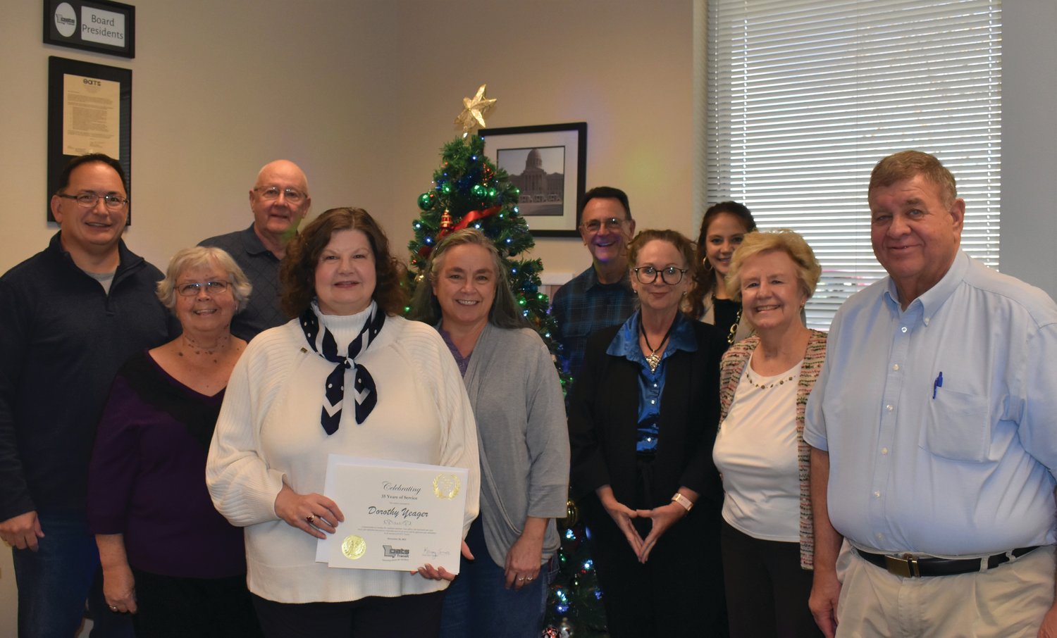 The OATS Transit Board poses with Dorothy Yeager. From left are Andrew Warlen, Jeff Leeman, Patricia Mefford, Dorothy Yeager, Krissy Sinor, Mel Sundermeyer, Julie Rogers, Stacey Steffens, Darleen Rapp and John Griesheimer.