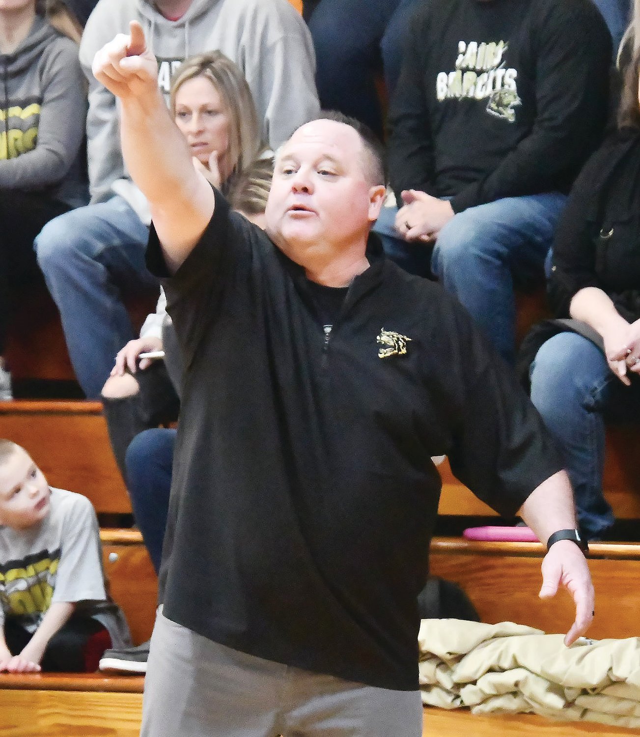 Cairo head girls' basketball coach Brian Winkler motions to his team from the sideline.