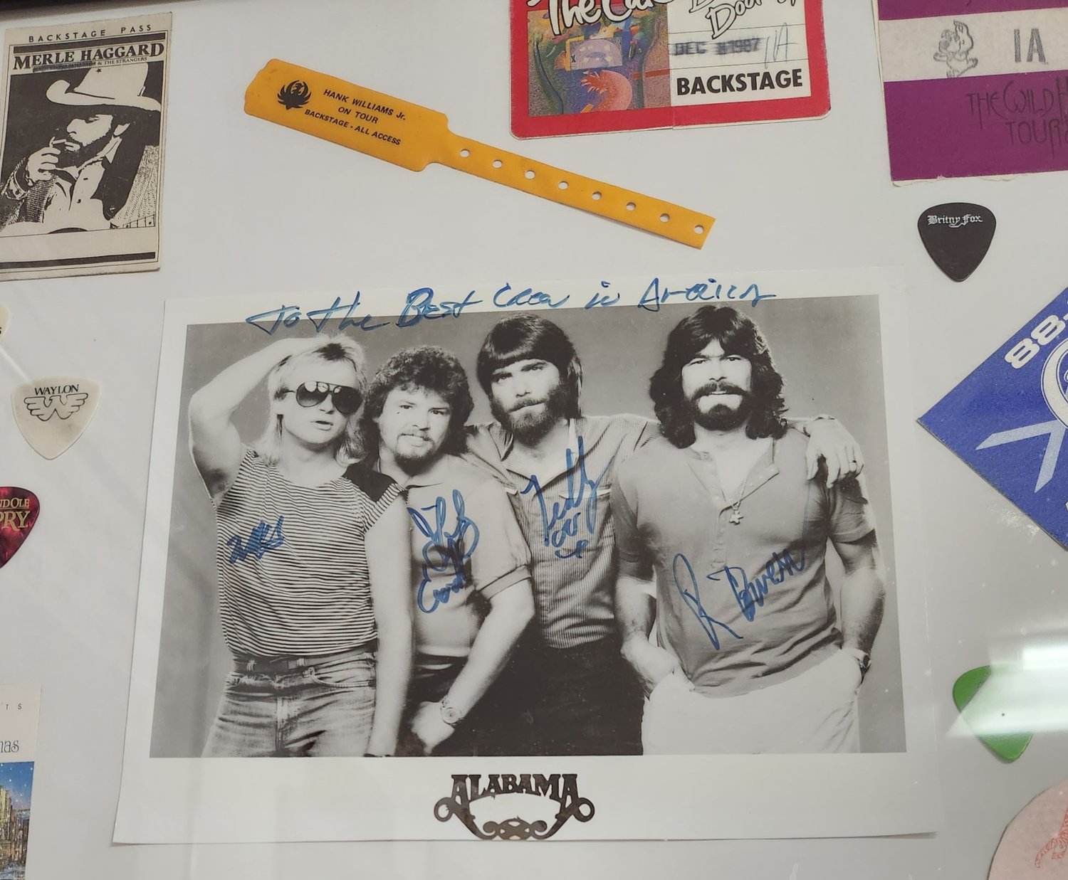 An autographed photo of Alabama on the wall of Backwoods Recordings studio.