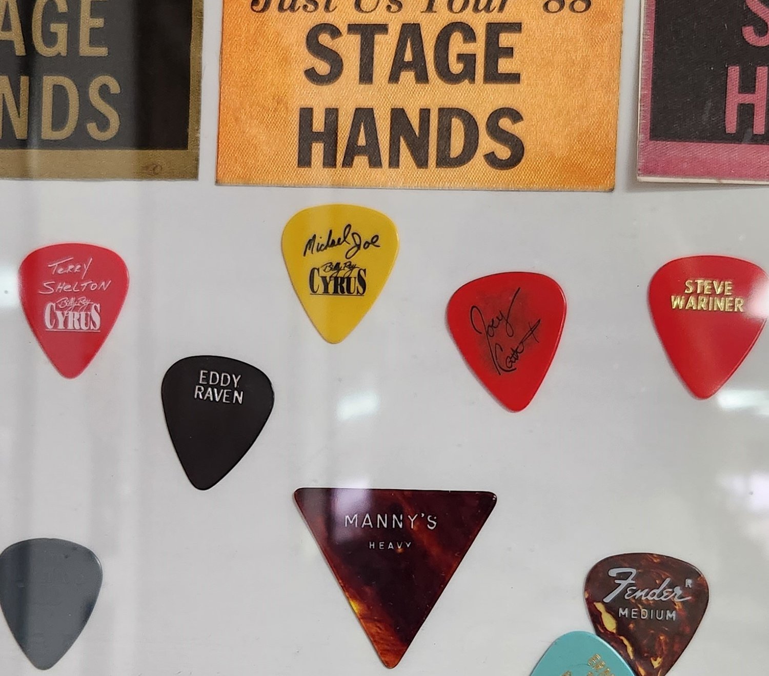 A few guitar picks from artists Lampkins worked for as a roadie.