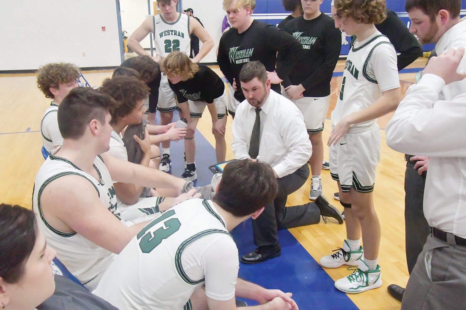 Westran head boys basketball coach Chris Sander talks with the Hornets during a second-half timeout.