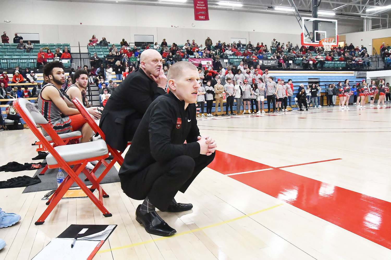 Moberly Area men's basketball coaches Pat Smith and James Hays (foreground) watch the action during the second half.