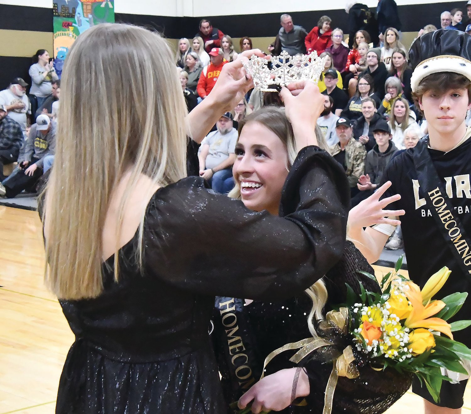 Gracie Brumley (right) receives her crown from 2022 Courtwarming queen Morgan Taylor.