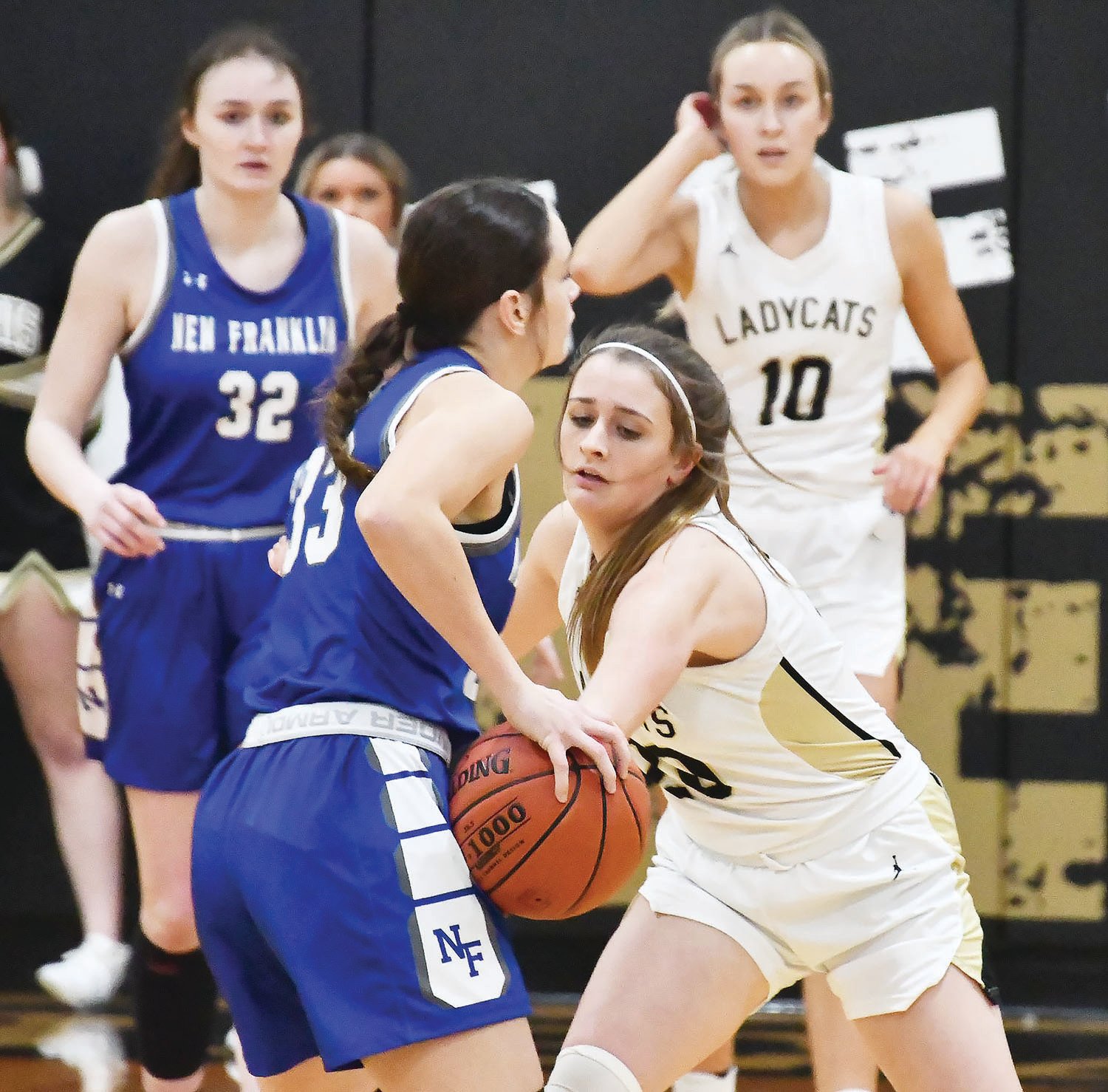 Cairo's Jersey Bailey pokes at the ball while playing defense as the Bearcats entertained New Franklin in a Central Activities Conference game Friday.