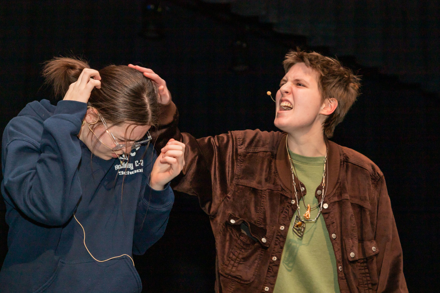Madeline Corderman, right, in the role of Susan Jones, hurls insults at her daughter, played by Paige Hull, during a rehearsal of “Discovering Amelia,” Moberly High School’s spring play.