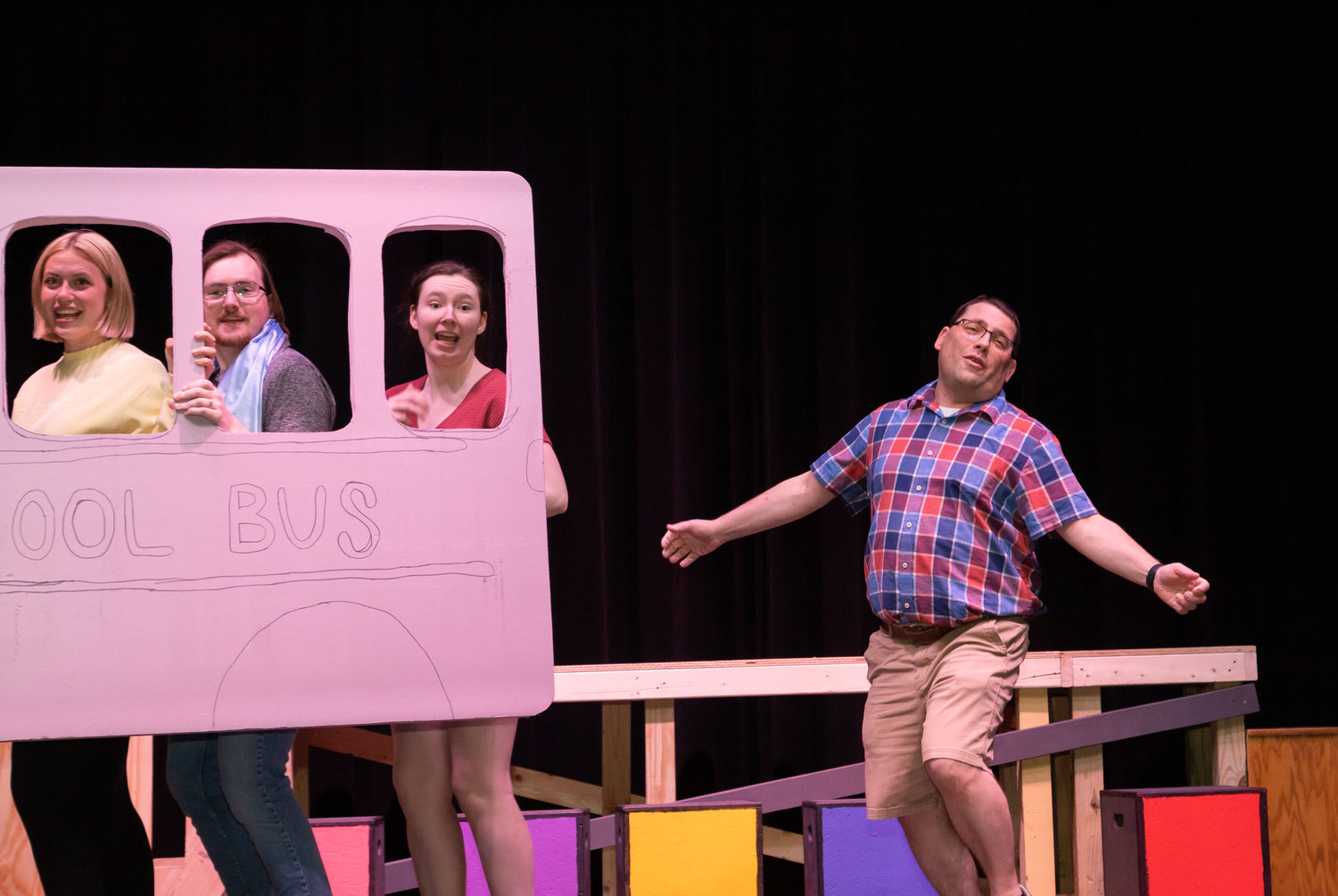 Charlie Brown (Ian Linenfelser) runs behind the school bus while Lucy (Abigail Klinkerman), Linus (Nate Gard) and Sally (Camille Blanford) ride.