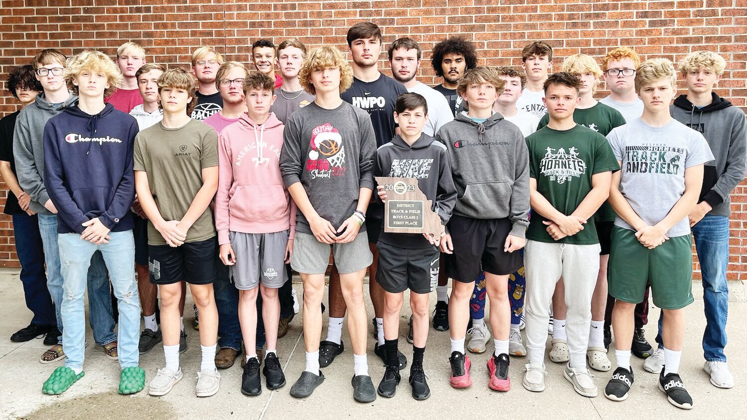 The complete Westran High School boys track and field team poses with the plaque they won at the Class 2 District 3 meet on Saturday, May 6, in Unionville.