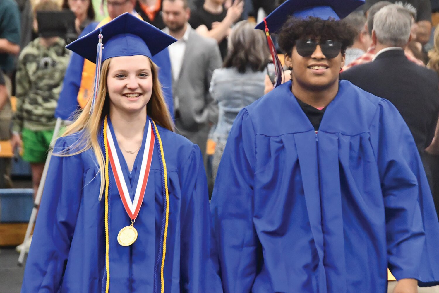 Moberly High School graduates Neveah Cleeton and Tyshaun Graves walk toward their seats during the processional.