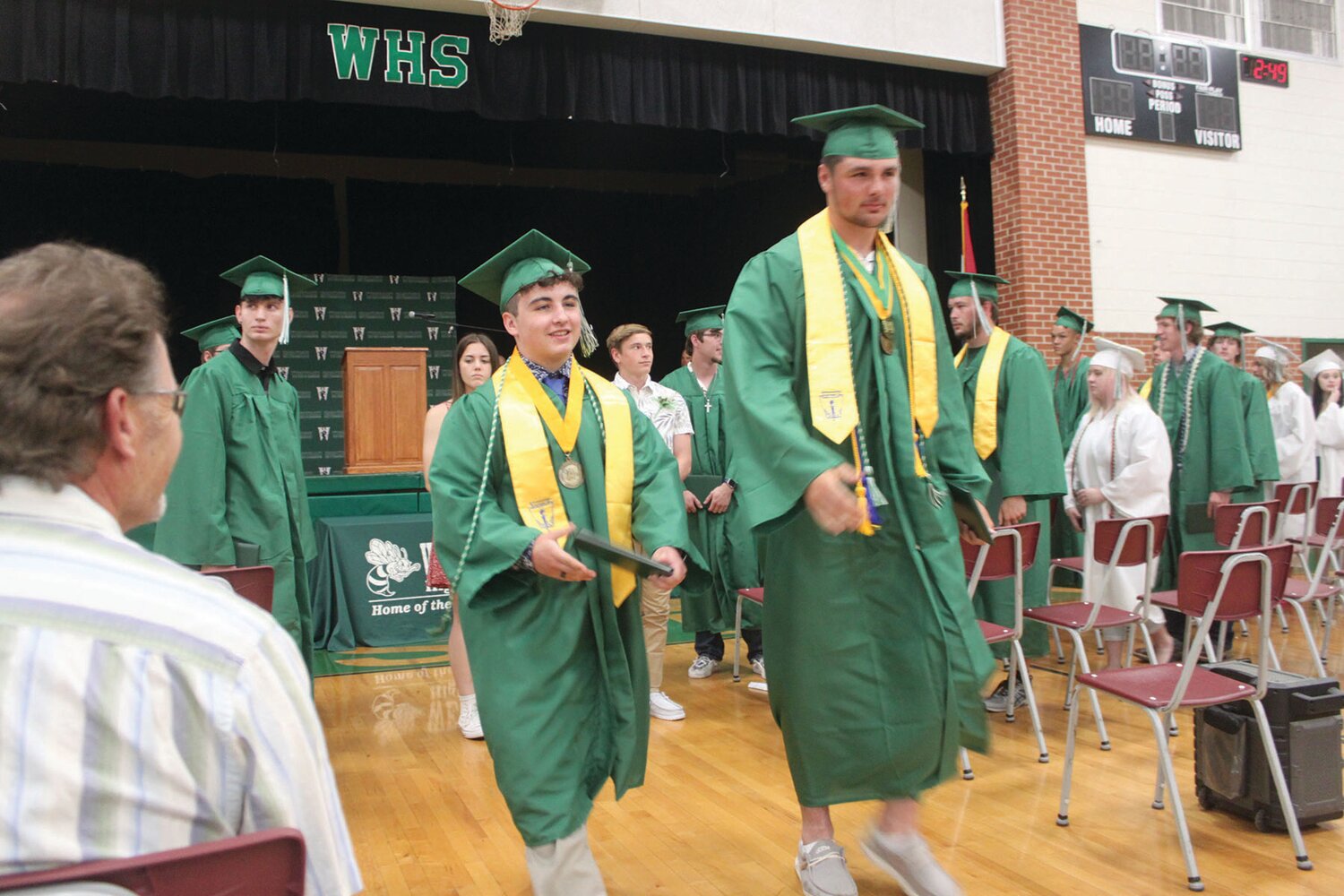 New graduates Brayden Sexton and Langden Kitchen walk together during the Westran High School commencement recessional May 14. The next time they walk through this gym, it will be as alumni.
