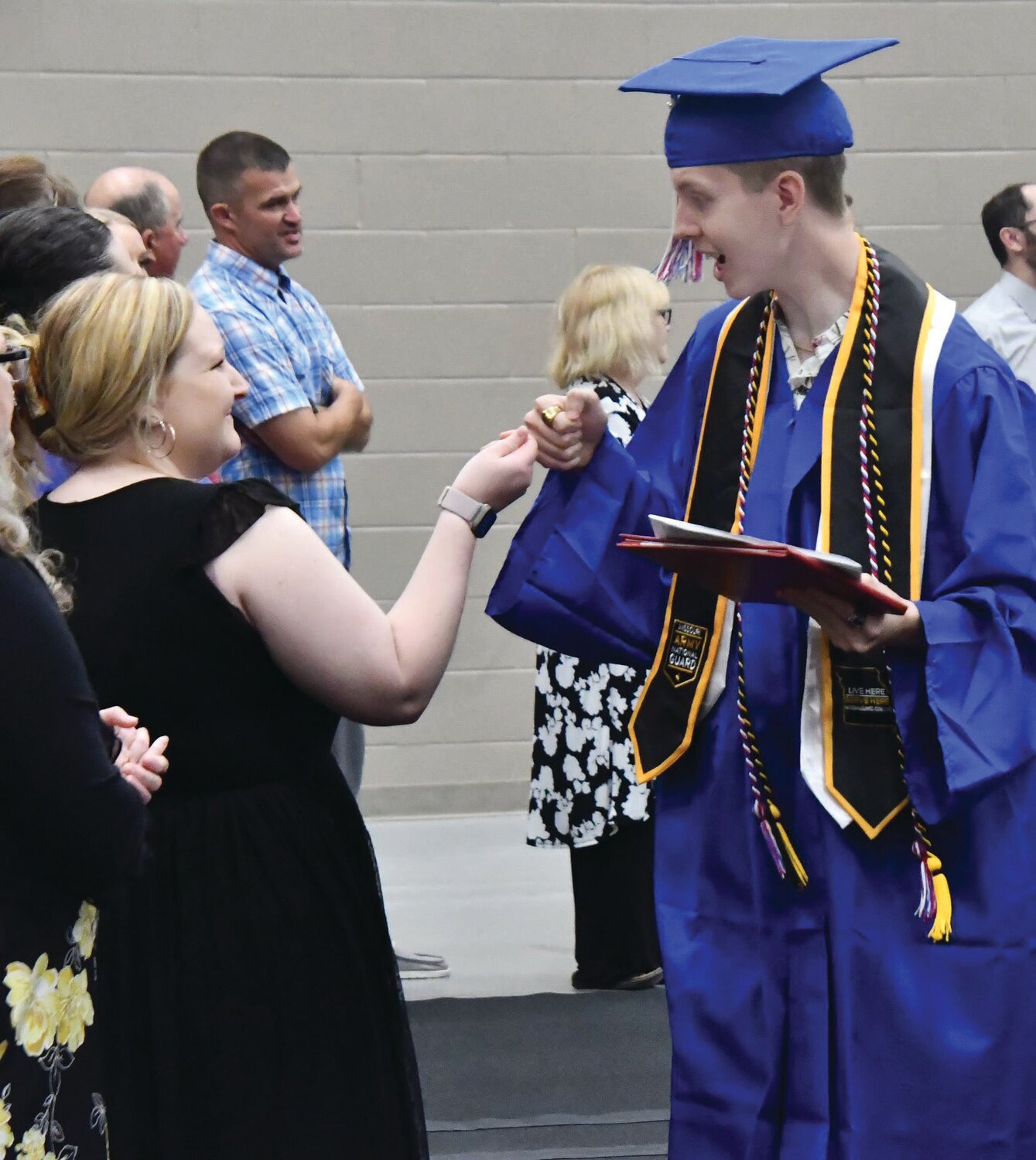 Moberly High School graduate Cory Cable receives a first bump from teacher Brandie Colbert during the tunnel walk at the end of the 55th Annual Commencement ceremony. The tunnel walk is a recently added attraction at the ceremony.