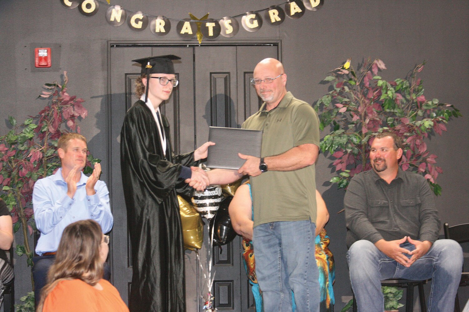 Renick salutatorian Vance Arrant receives his diploma from Josh Taylor, school board president.