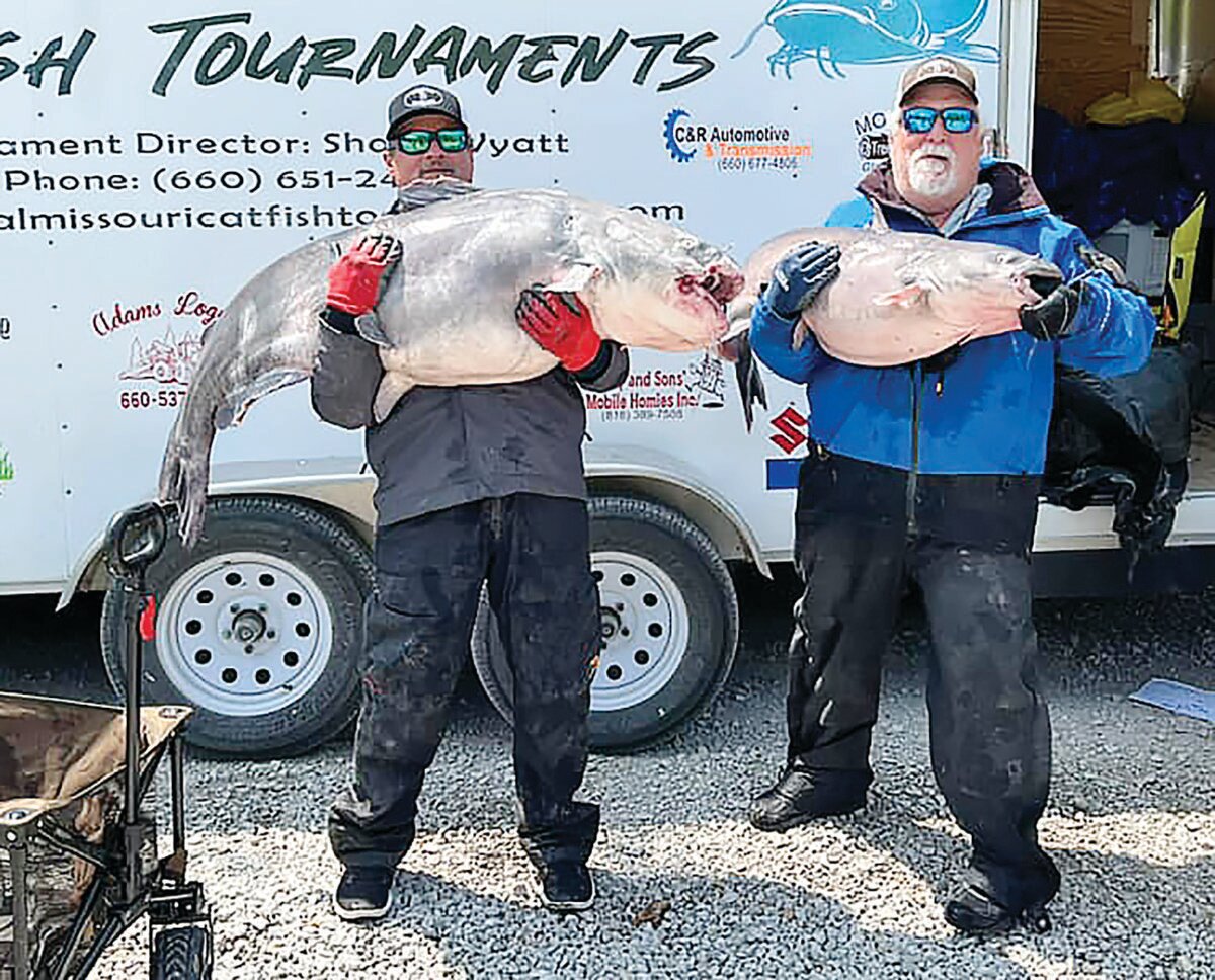 Troy Phillips (left) and Chris Brinegar show off two of the catfish they reeled in during the Central Missouri Catfish Tournaments tour stop in Dalton on Saturday, May 6.