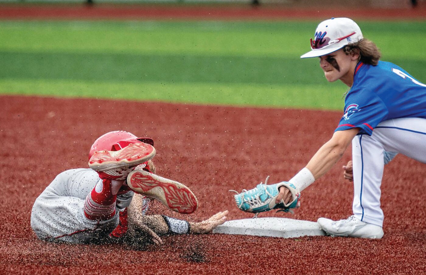 Moberly second baseman Braedon Hunt attempts to apply a tag during Saturday's Class 4 District 7 game at Macon High School. This marked Hunt's final scholastic game as Mexico defeated the Spartans, 11-1, in six innings.
