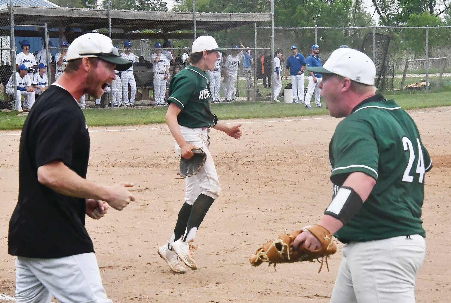 Westran High School head baseball coach Tyler Tanner (left) and Rick Stephenson (24) right react after Westran turns a double play to end last Tuesday's regular-season game versus Atlanta. The Hornets have found their stride in recent games.