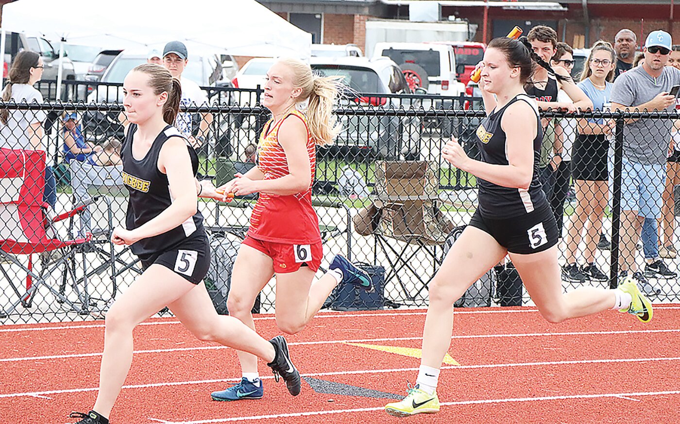 Higbee's Joey Westfall (left) prepares to accept the baton from teammate Isabelle Welch during the Class 1 Section 2 meet at South Shelby High School in Shelbina.