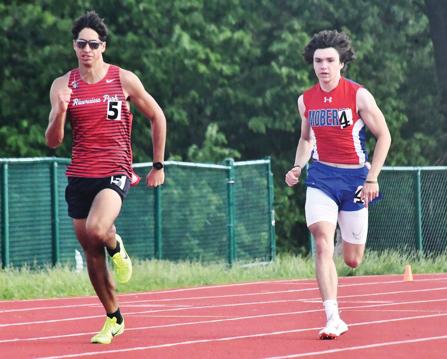 Moberly's Brett Gelina (right) competes versus a Hannibal runner during the 400-meter dash Saturday, May 13.