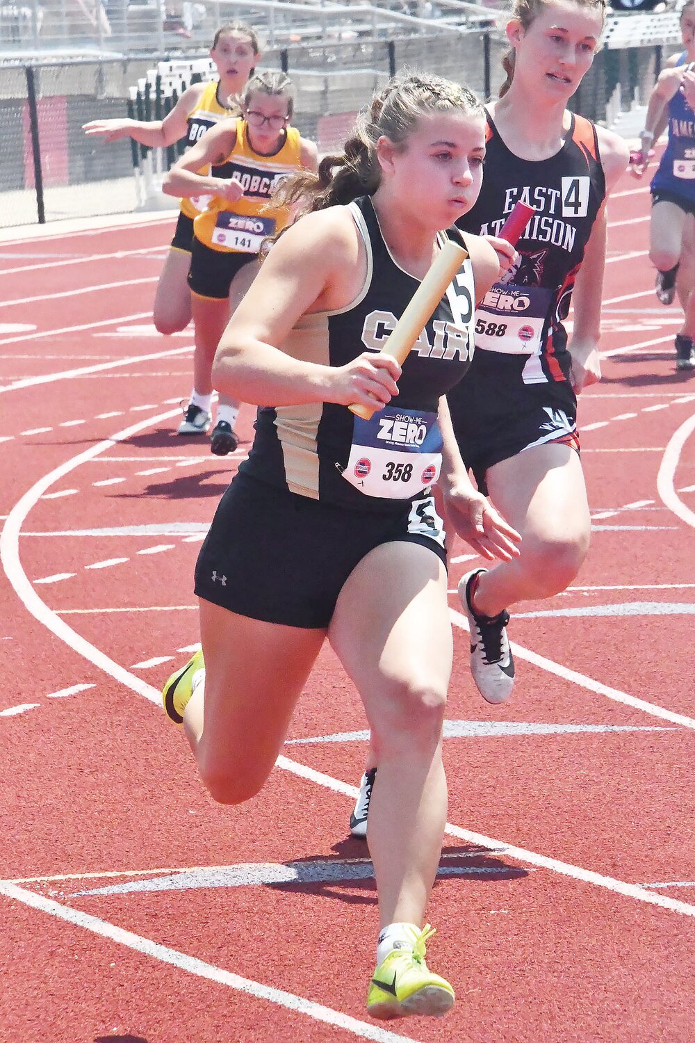 Olivia Cross rounds the curve with the baton during the Class 1 4x200-meter relay at the Class 1 state track and field meet in Jefferson City on Saturday, May 20.
