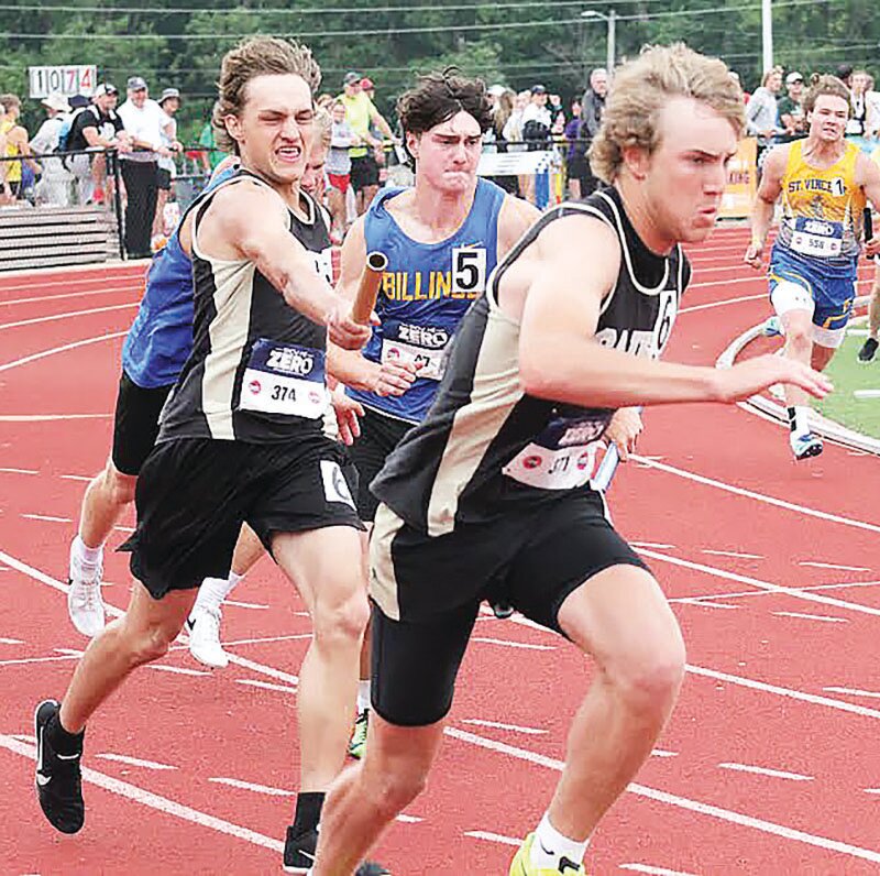 Cairo's Hayden Holman accepts the baton from teammate Justin Thrasher during a relay at the Class 1 state track and field meet.