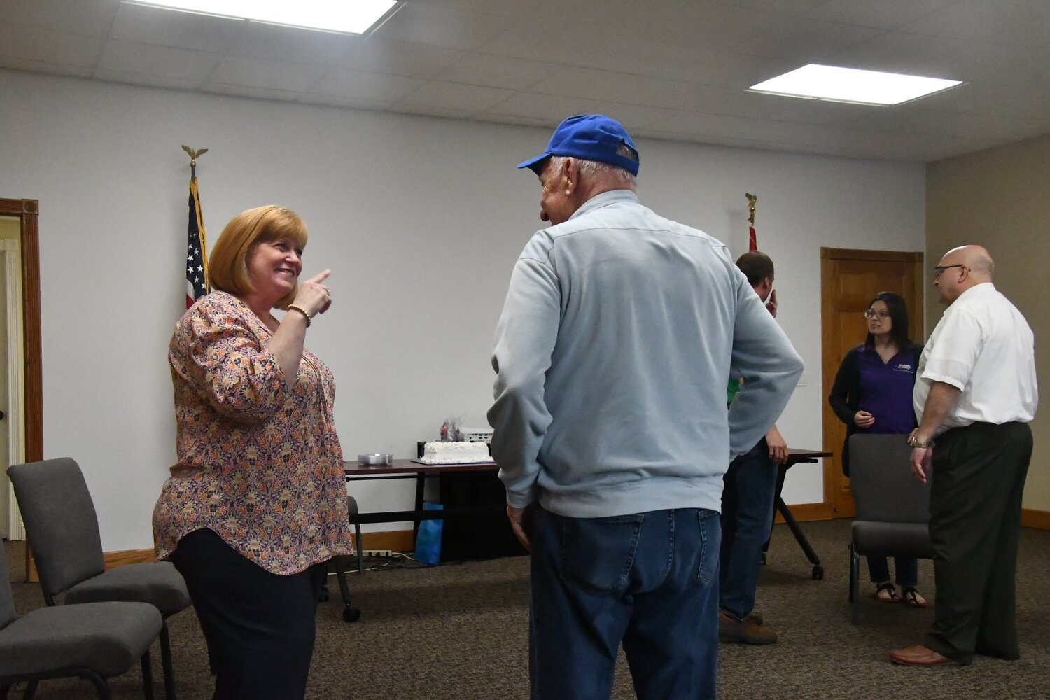 Pam Kertz, a former administrative assistant with the Moberly Parks and Recreation Department office, shares a moment with Jerry Calvin during a meet-and-greet at city offices on Friday, May 12. (Photo by Eric Viccaro)