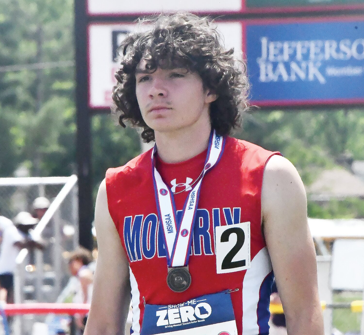 Moberly's Brett Gelina listens as his name is called as Class 4 200-meter dash champion, clocking in with a season-best time of 21.33 seconds.