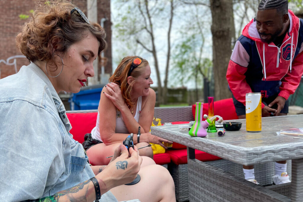 A group relaxes April 20 during the Green Light District Cannabis Crawl in St. Louis. (Rebecca Rivas/Missouri Independent)