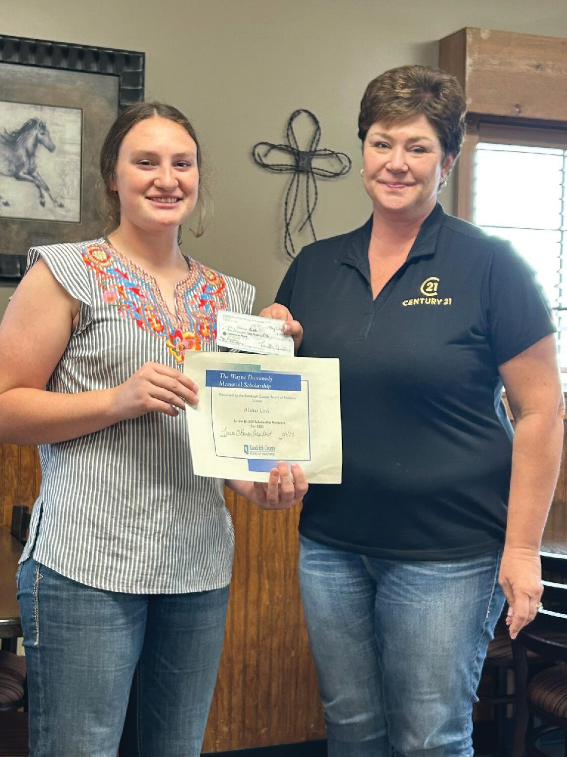 Alaina Link, left, a current student at the University of Missouri, received a $1,500 scholarship to further her studies in an agricultural field. Also pictured is Julie Green, president of the Randolph County Board of Realtors.