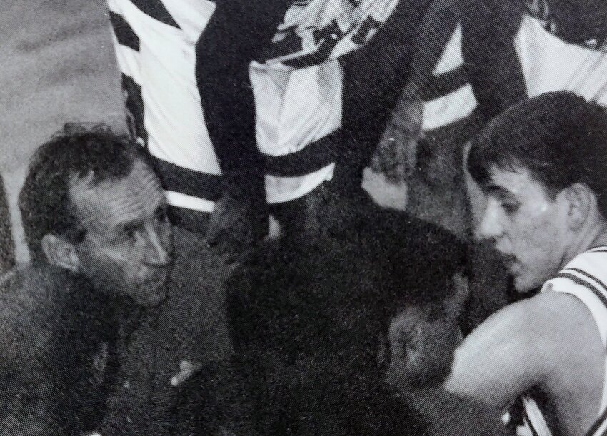 Freedom coach Terry Rogers (left) looks on as senior point guard Casey Rogers (right) talks to a teammate during a timeout in a game during the 1997-98 season. The Patriots finished the year with a record of 30-1, winning the program's second state title in the sport.