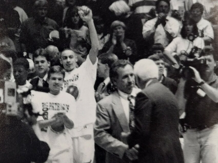 Freedom coach Terry Rogers receives congratulations from an official with the North Carolina High School Athletic Association in the moments after the Patriots won the 1998 4A state title at the Smith Center in Chapel Hill.