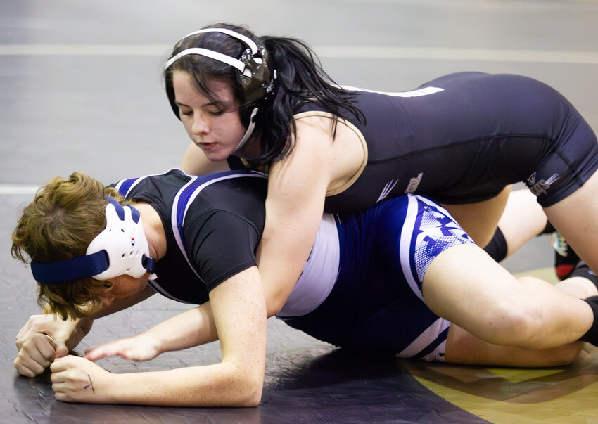 Draughn's Mackenzie Barrett (top) wrestles North Carolina School for the Deaf's Emily Elliott in the 126 weight class on Wednesday in Valdese.