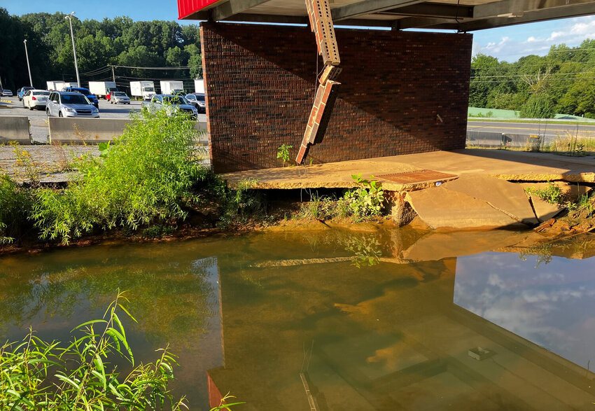 The giant sinkhole next to the Morganton Post Office remains a threat to both nearby roads and to the Catawba River.