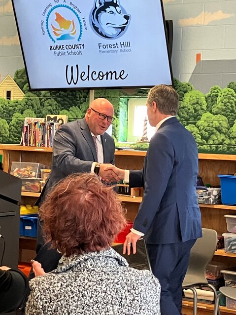 Burke County Public Schools Superintendent Dr. Mike Swan shook hands with Governor Roy Cooper.