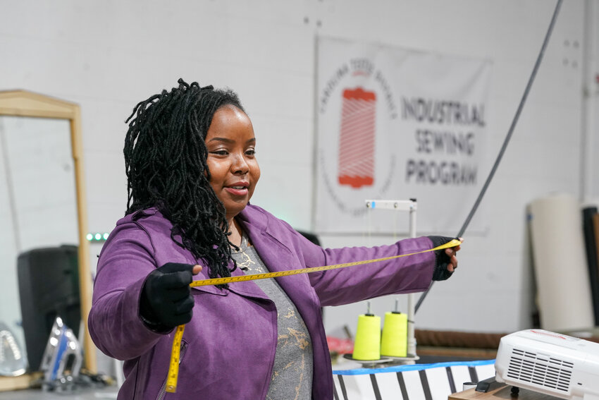 Ashley Dula offers measuring tips during her Industrial Sewing Boot Camp at the Carolina Textile District at the Industrial Commons.