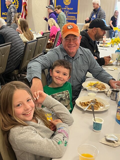 Noelle and Noah Tolbert feasted with their grandfather, Mark Tolbert, at the Morganton Rotary Club's pancake breakfast at the Morganton Community House last Saturday. The fundraiser attracted a large crowd.