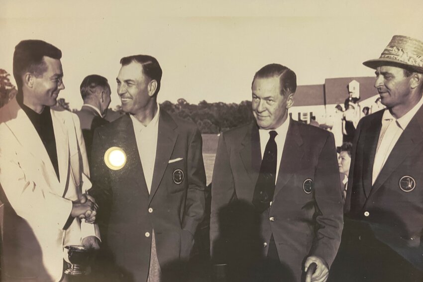 Billy Joe Patton (left) shakes hands with nine-time major winner and defending Masters champion Ben Hogan as Patton led after two rounds of the 1954 Masters.