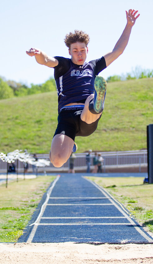 East Burke's KJ Byrd takes flight in the boys long jump event at the Odell Williams Invitational meet in Icard on April 13. Byrd won three events as the Cavalier boys topped the 15-team field.