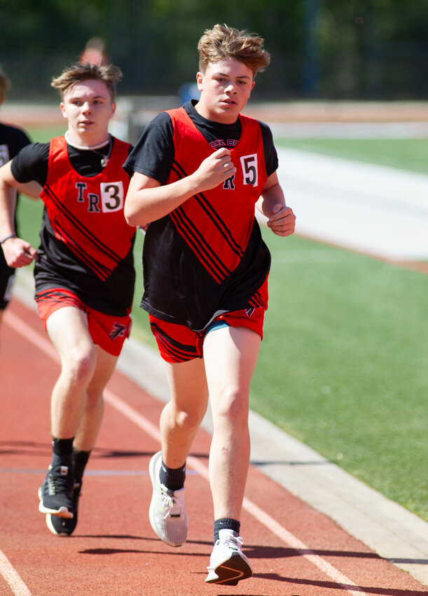 Table Rock's Ryder Huffman (right) and Christian Lawhon compete in the 1600 meters during Tuesday's Foothills Athletic Conference championship meet at McDowell High School. The Falcons' boys team finished first to collect the school's first FAC team title since 2017.