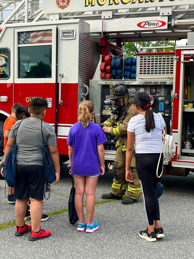 Safe Haven campers gather around as they learn more about the Morganton Public Safety fire division.
