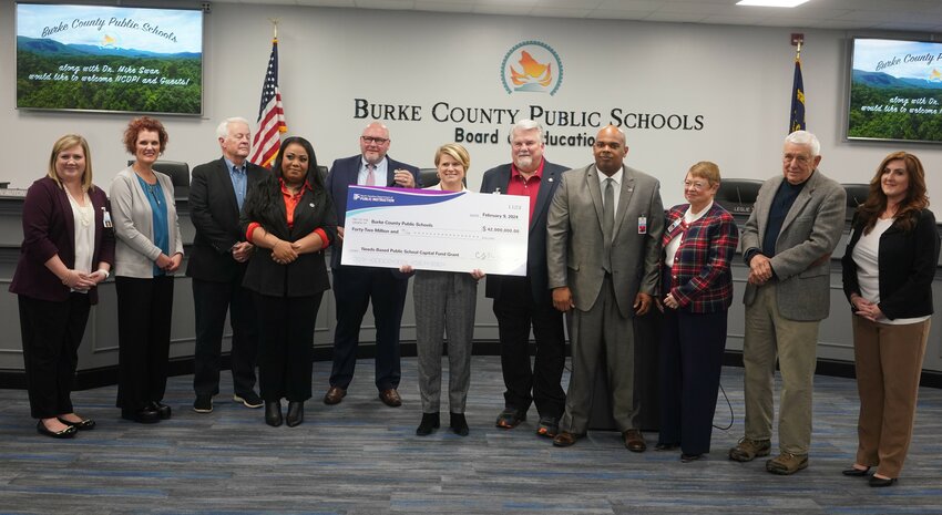 North Carolina Superintendent of Public Instruction presented the Burke County Board of Education members and district leadership in February. Also attending was Rep. Hugh Blackwell. The grant is earmarked to build a new school in east Burke.